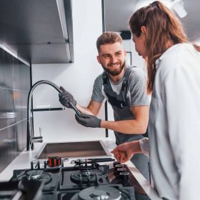 young-professional-plumber-in-grey-uniform-shows-results-of-work-for-housewife-on-the-kitchen.jpg young-professional-plumber-in-grey-uniform-shows-results-of-work-for-housewife-on-the-kitchen.jpg